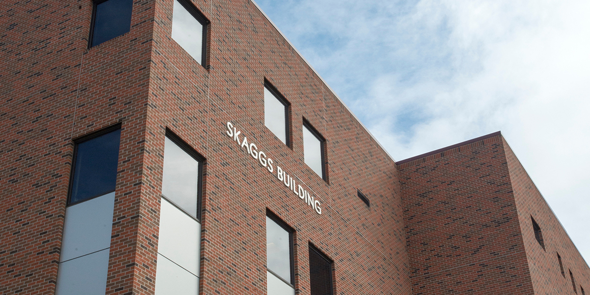 Silver letters on a brick building spell out "Skaggs Building"
