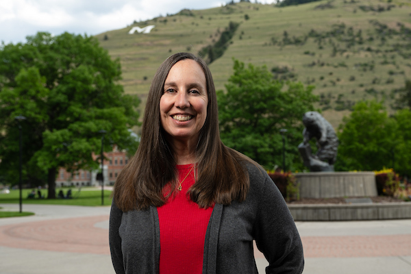 Director of Admissions Kelly Nolin smiles for a portrait in front of the grizzly bear statue along the Oval on the University of Montana campus in Missoula, MT.